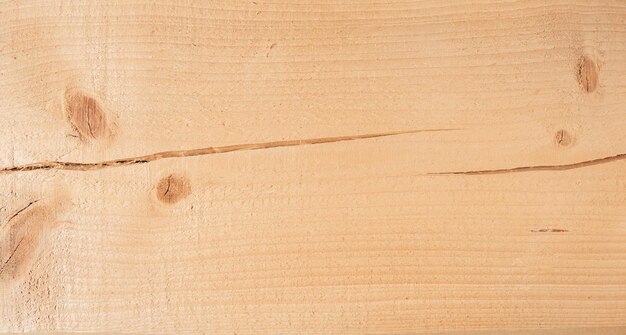 Bright pine board texture with knots and crack