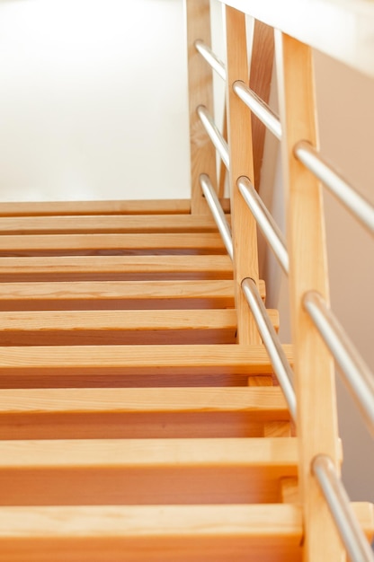 Photo bright pine stairs leading to the first floor