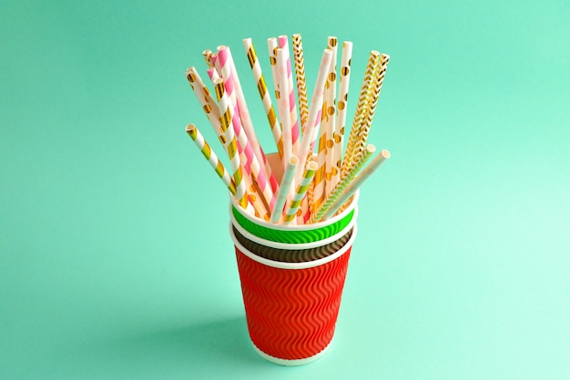 Bright pink and golden tubules in a paper cup. Copy space.