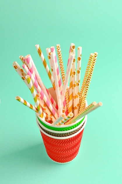 Bright pink and golden tubules in a paper cup. Copy space.