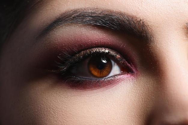 Bright pink professional makeup on eyes of woman closeup