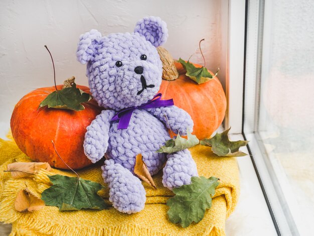 Bright plush toy sitting on a windowsill