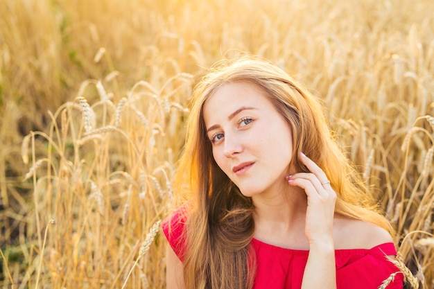 Bright portrait of happy young woman at summer field