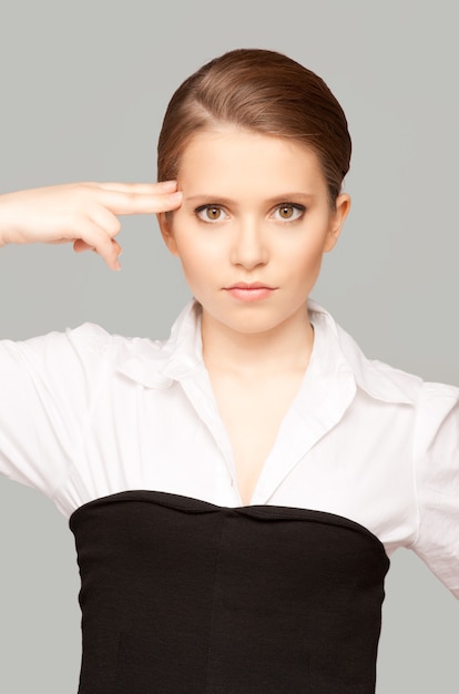 bright Portrait of unhappy woman showing suicide gesture