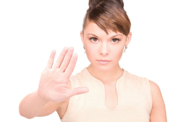 bright portrait of young woman making stop gesture