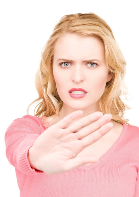 bright Portrait of young woman making stop gesture