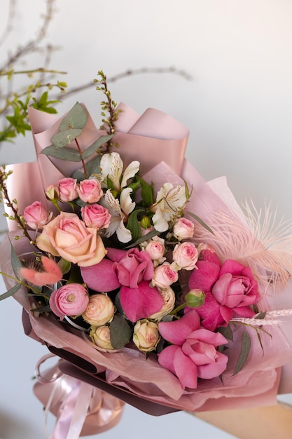 Bright powdery bouquet with feather branches roses alstroemeria eucalyptus