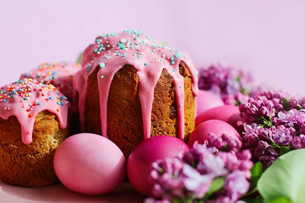 Bright purple easter eggs cake and lilac flowers on a purple background Easter decor