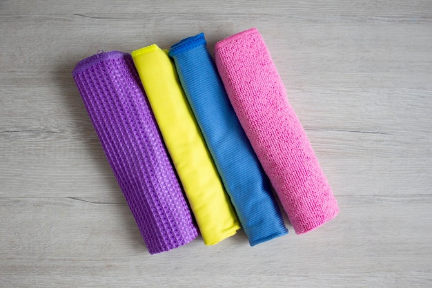 Bright purple pinkblue and yellow colorful set of towels closeup fabric texture on wooden background