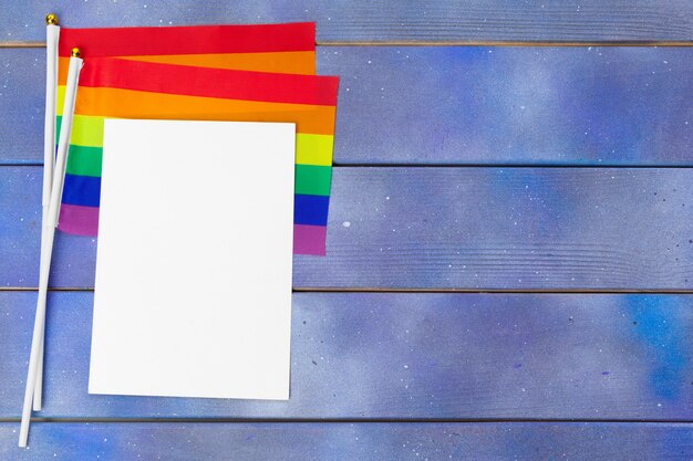 Bright rainbow gay flag on wooden background and blank space