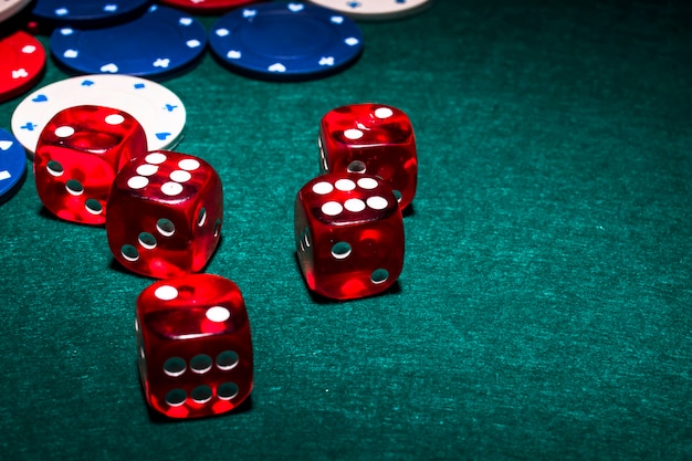 Bright red dices on green poker table