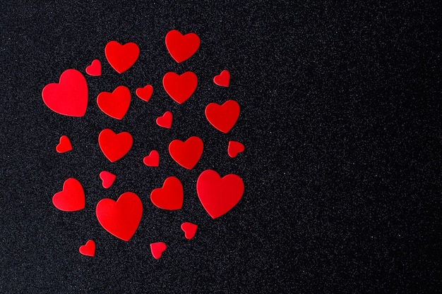 Bright red hearts for lovers on a black background Happy Valentine's Day