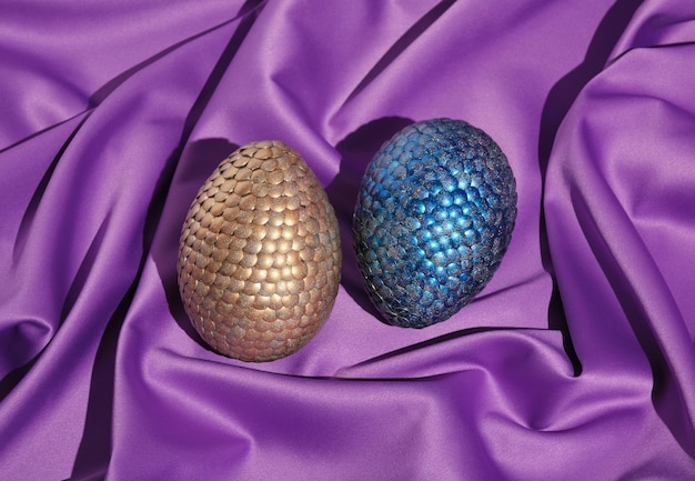Bright shiny magic dragon eggs on colorful textile background. Aesthetic of natural beauty and magiс.