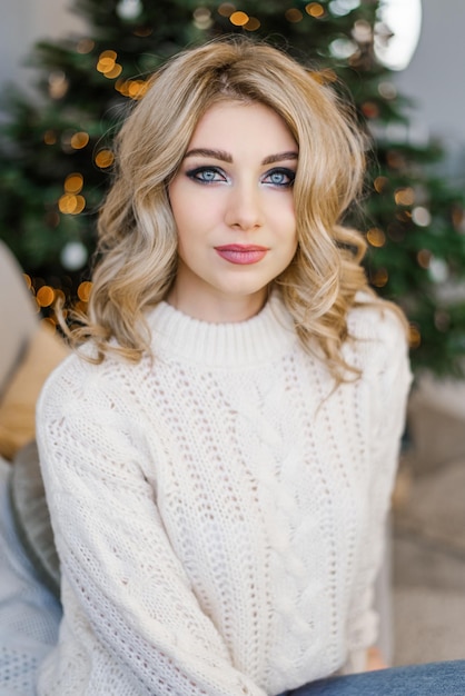 Bright smokey eyes makeup on a pretty young girl and hairstyle curls