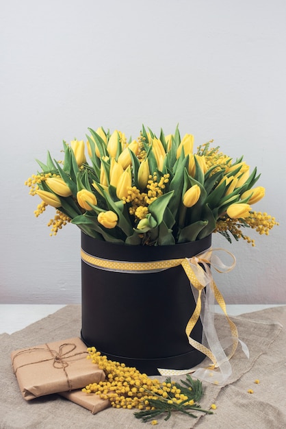 Bright spring bouquet of tulips and mimosa flowers