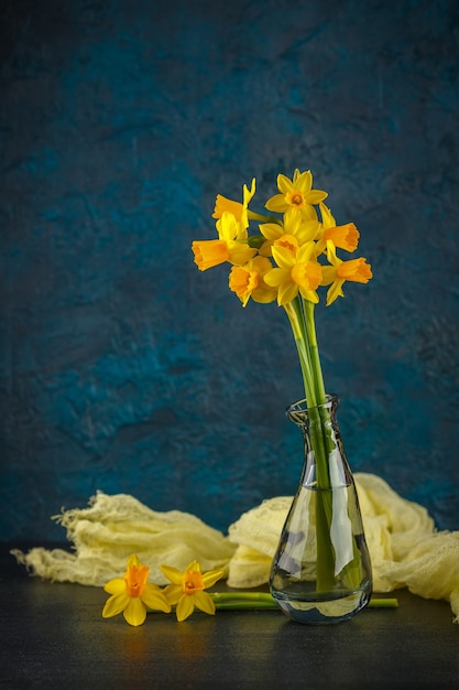 Bright spring yellow miniature daffodils in glass vases