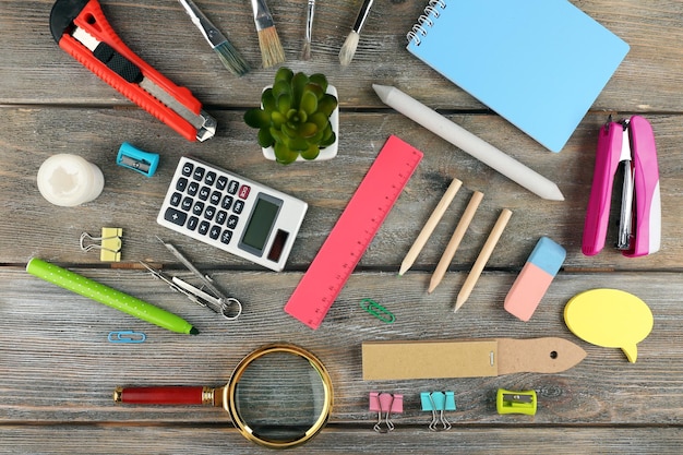 Photo bright stationery objects on wooden table close up