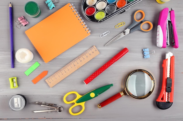 Bright stationery objects on wooden table close up