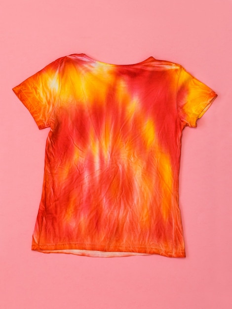 Bright t-shirt in tie dye style. Flat lay. Staining fabric in tie dye style. Flat lay.