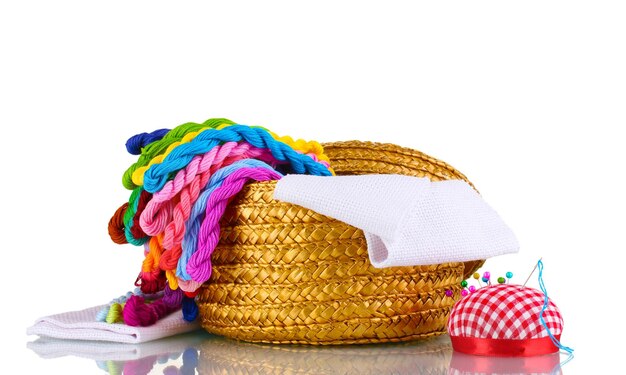 Bright threads for needlework and fabric in a wicker basket