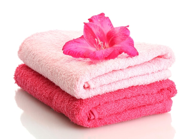 Bright towels and flower isolated on white