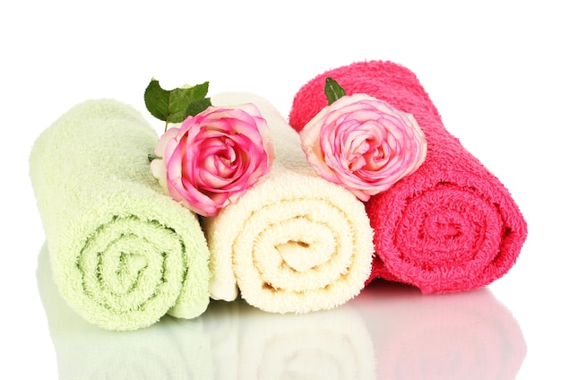 Bright towels and roses isolated on white