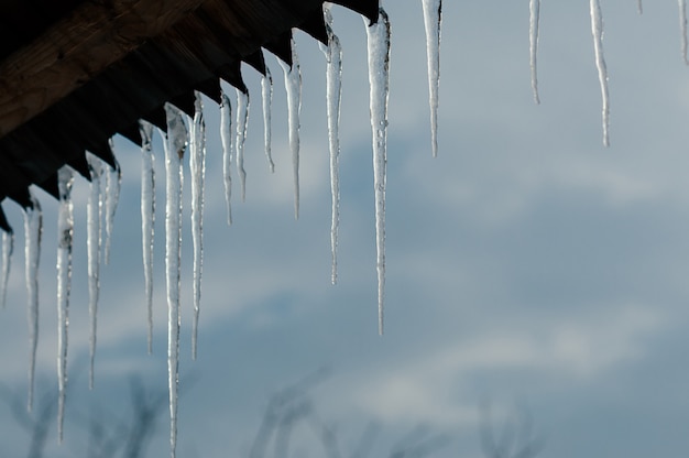 Bright transparent icicles against blue sky