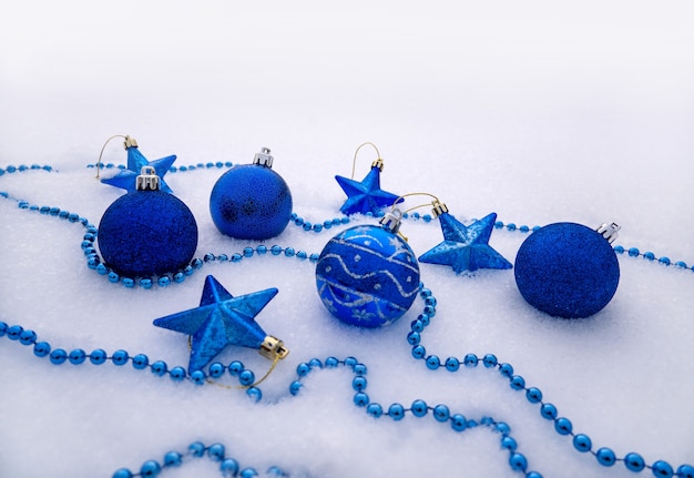 Bright trinkets Christmas balls snowflakes and stars in the snow christmas decorations