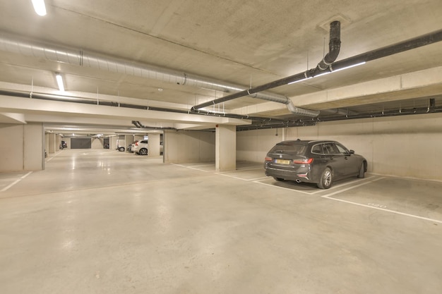 Bright underground parking design under the building with markings and several cars