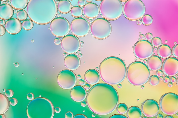 Bright and unique oil drops, circles on the water surface. Unusual background. Colorful wallpaper of  bublles