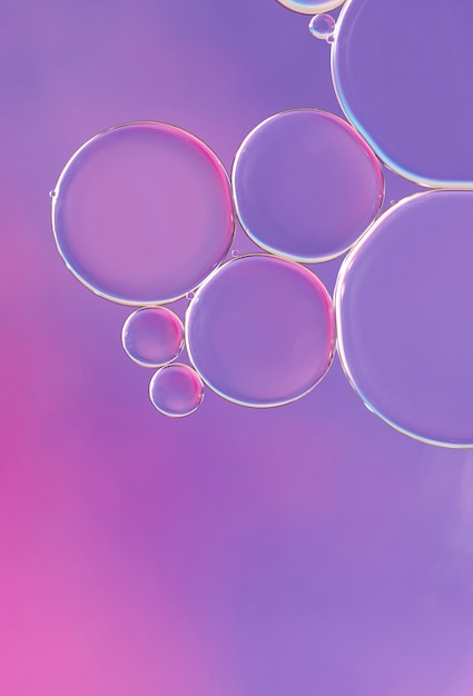 Bright and unique oil drops, circles on the water surface. unusual background. colorful wallpaper of bublles