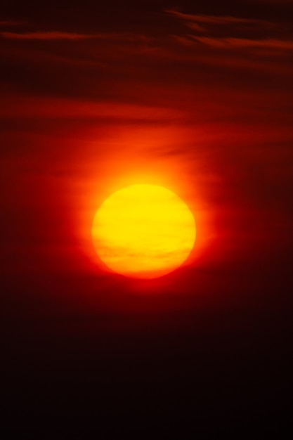 Bright warm sun on sky background. Dawn or sunset.