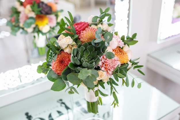 Bright wedding bouquet of summer dahlias and roses