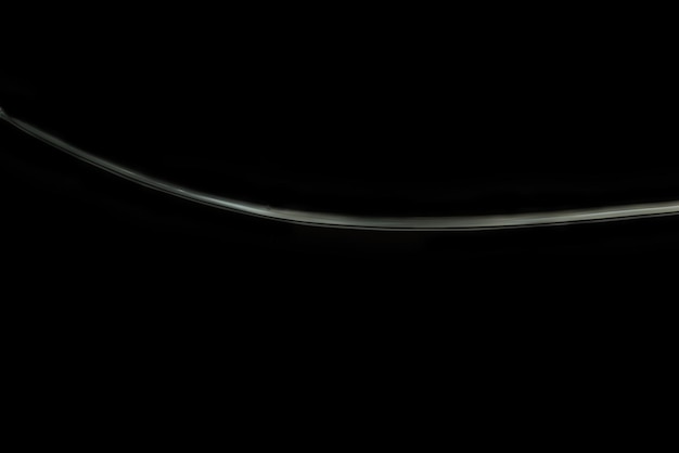 Bright white line of water ripple with black background