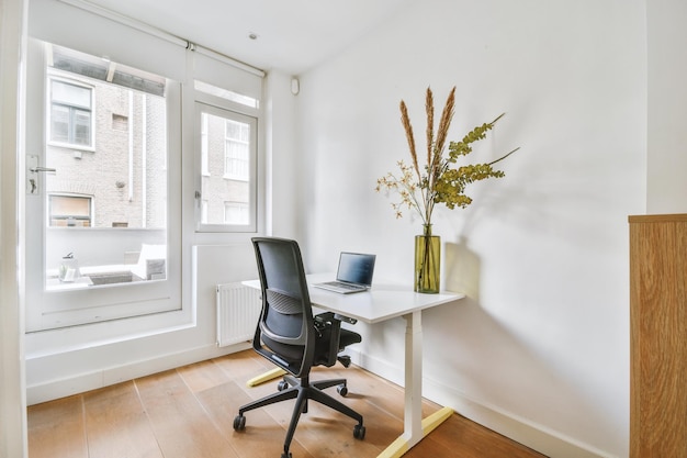 A bright white work area with a small laptop