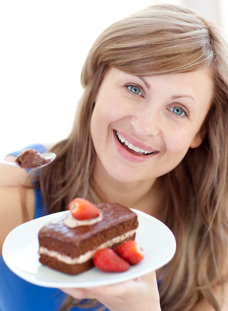 Bright woman holding a piece of chocolate cake 