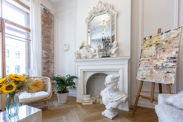 Bright workshop room for the creation and work of an architect and artist in a loft style with brick walls and parquet. the walls are decorated with examples of stucco.