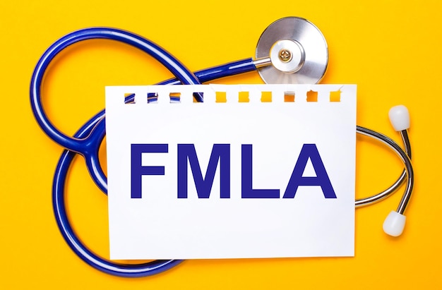 On a bright yellow background a blue stethoscope and a sheet of paper with the text FMLA Medical concept