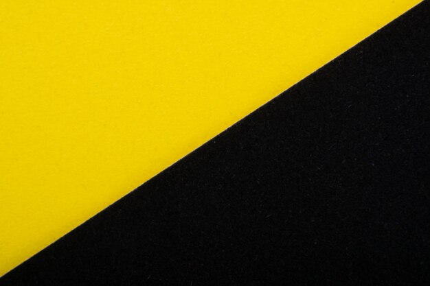 Bright yellow and black color paper texture background. Velvet cardboard