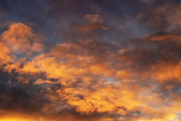 Bright yellow clouds at sunset in sky