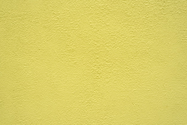 Bright yellow fine texture of plaster. Background.