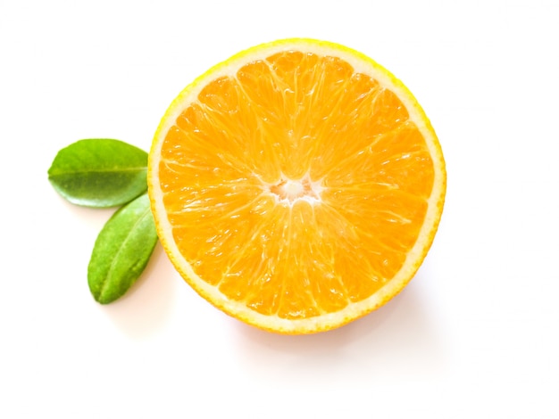 Bright yellow fresh citrus with half cut of orange fruit and green leaf 
