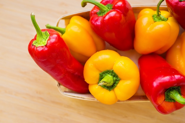 Bright yellow and red peppers closeup on the table