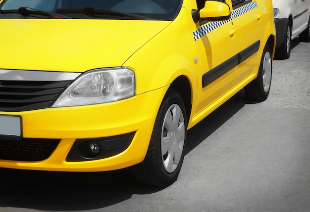 Bright yellow taxi cab on city street