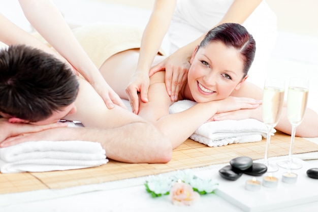 Bright young couple enjoying a back massage