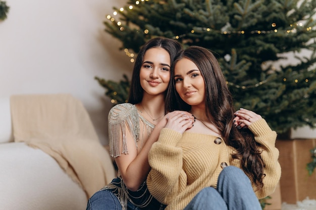 Brightfull expressions of happy emotions of two amazing girls celebrating new year 2023