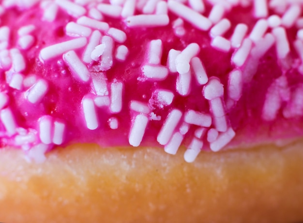 Brightly pink donut on a white background.