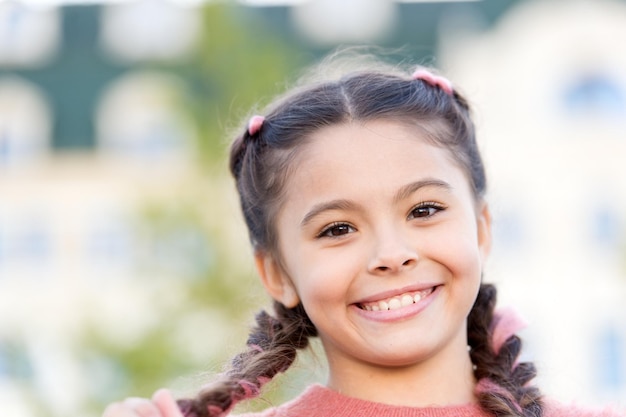 Brilliant smile Sincere emotional kid Girl emotional face Childhood and happiness concept Kid happy beautiful face Emotions concept Satisfied girl close up Emotional expression Having fun