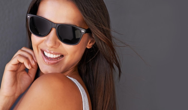 Brimming with confidence shot of a beautiful young woman wearing sunglasses