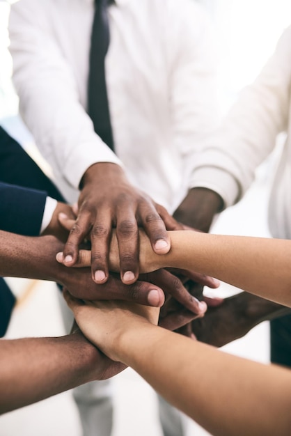 Bring it in team Shot of a motivated group of unrecognizable businesspeoples hands forming a huddle